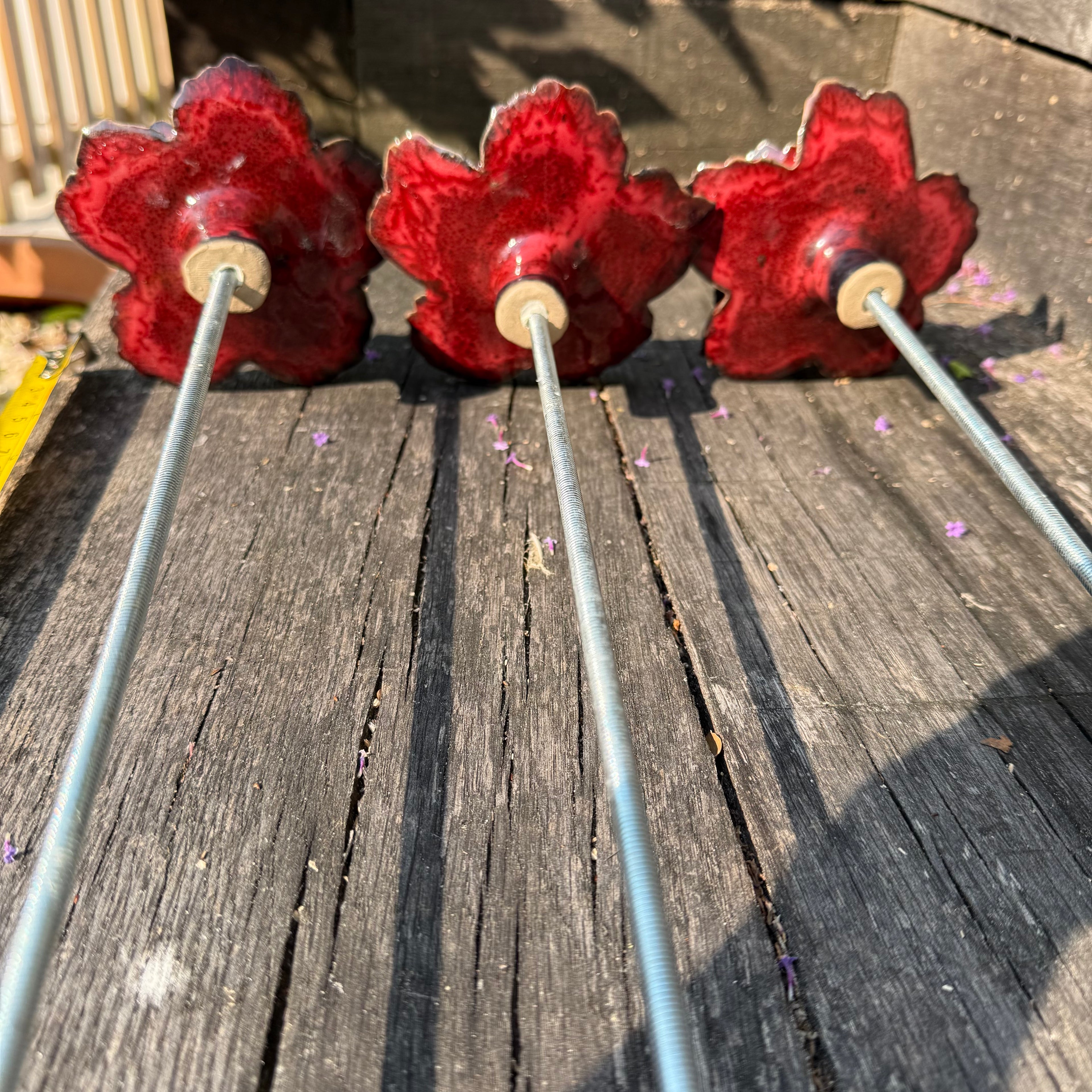 Red poppy garden ceramic flowers on tall metal stems
