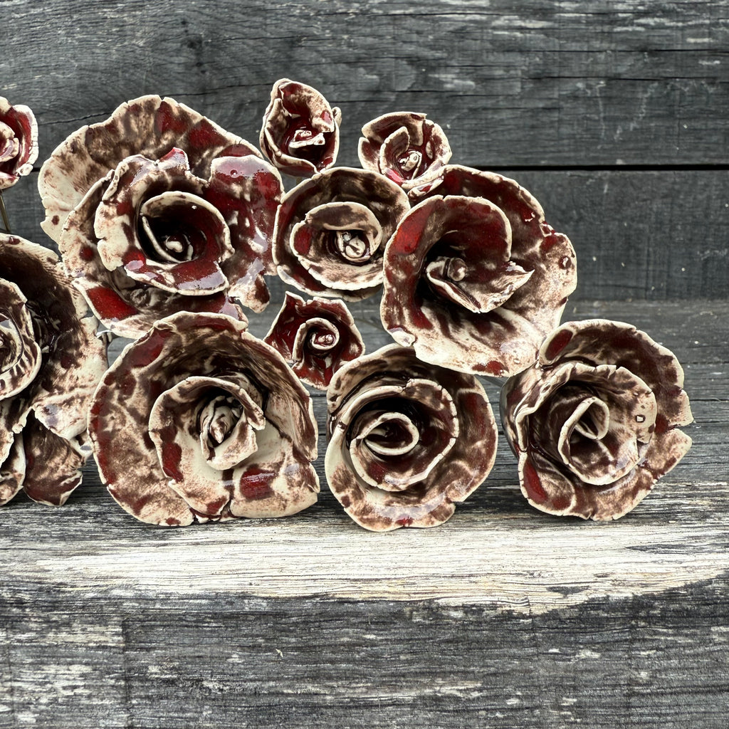 Decorative ceramic flowers on a wooden surface