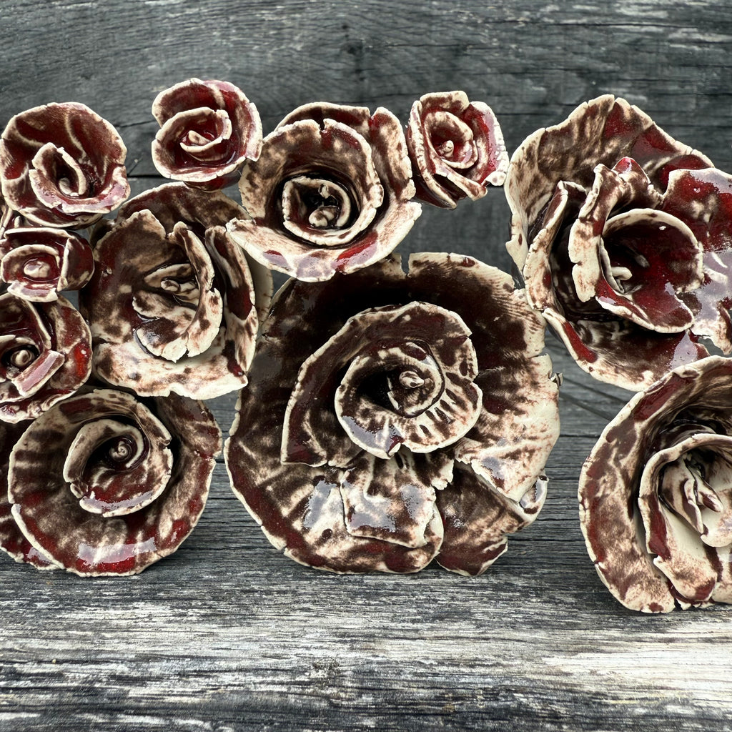 Decorative ceramic roses on a wooden surface