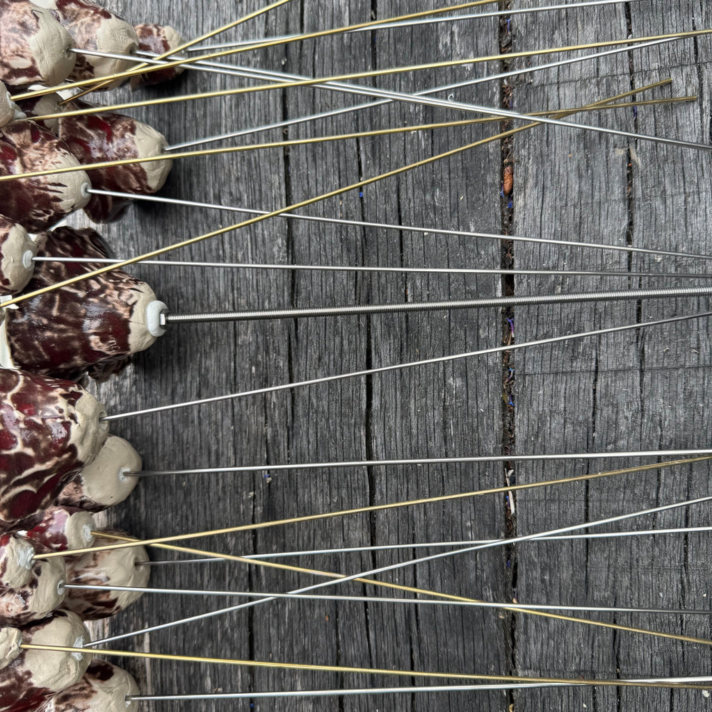 A whole bouquet of 21 rustic reds ceramic roses - each on metal stem