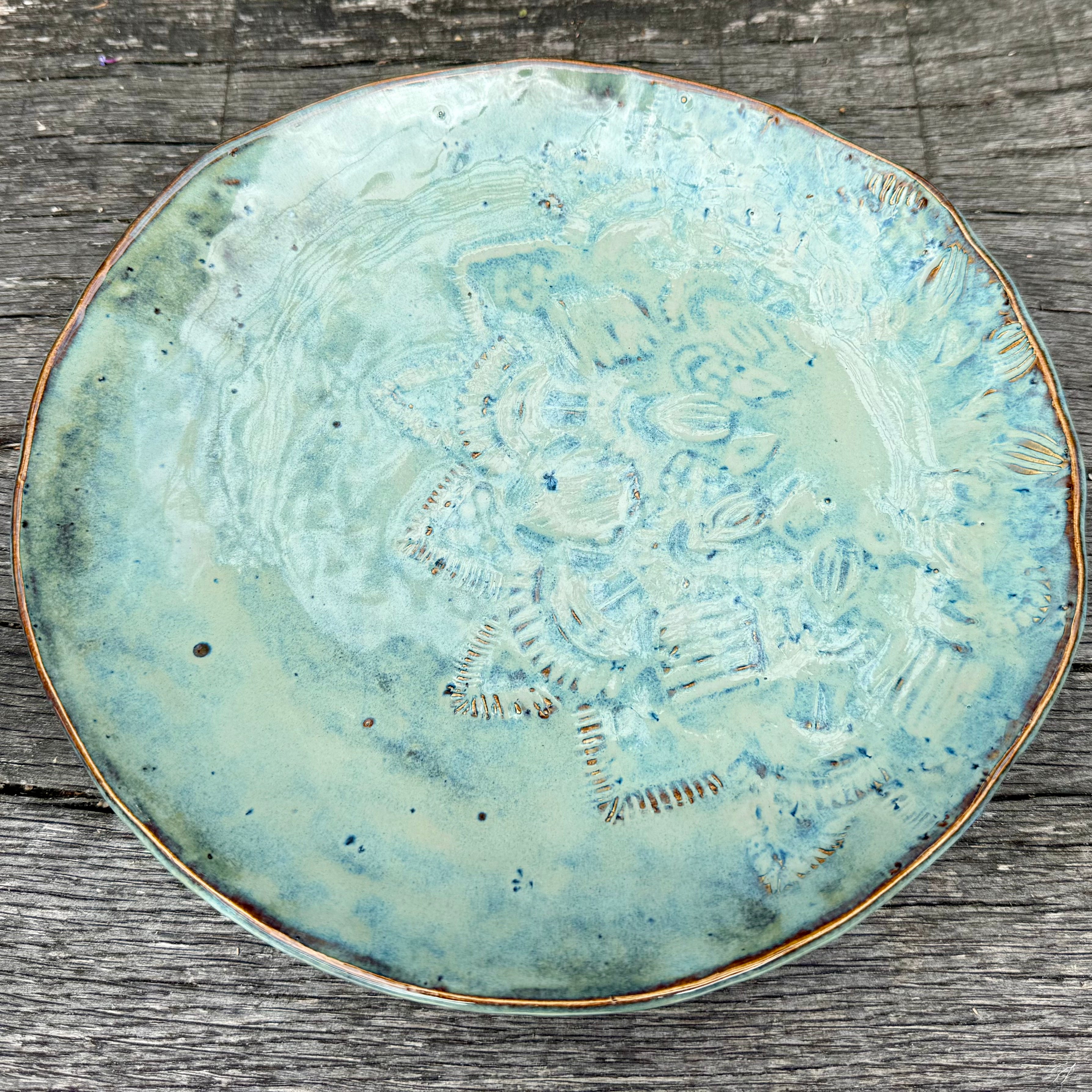 Ceramic plate with textured design on a wooden surface